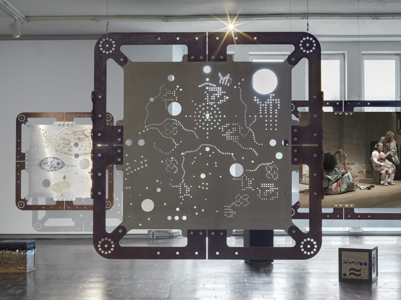 Modern art installation with geometric shapes and interactive elements in a gallery.