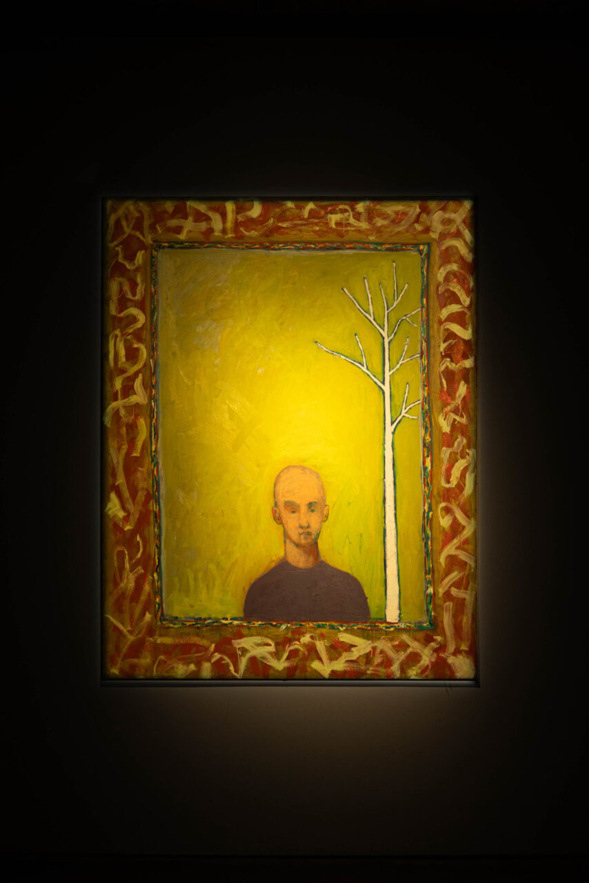 Painting of a young bald man against a yellow background with a sparse tree, framed by a colorful border.